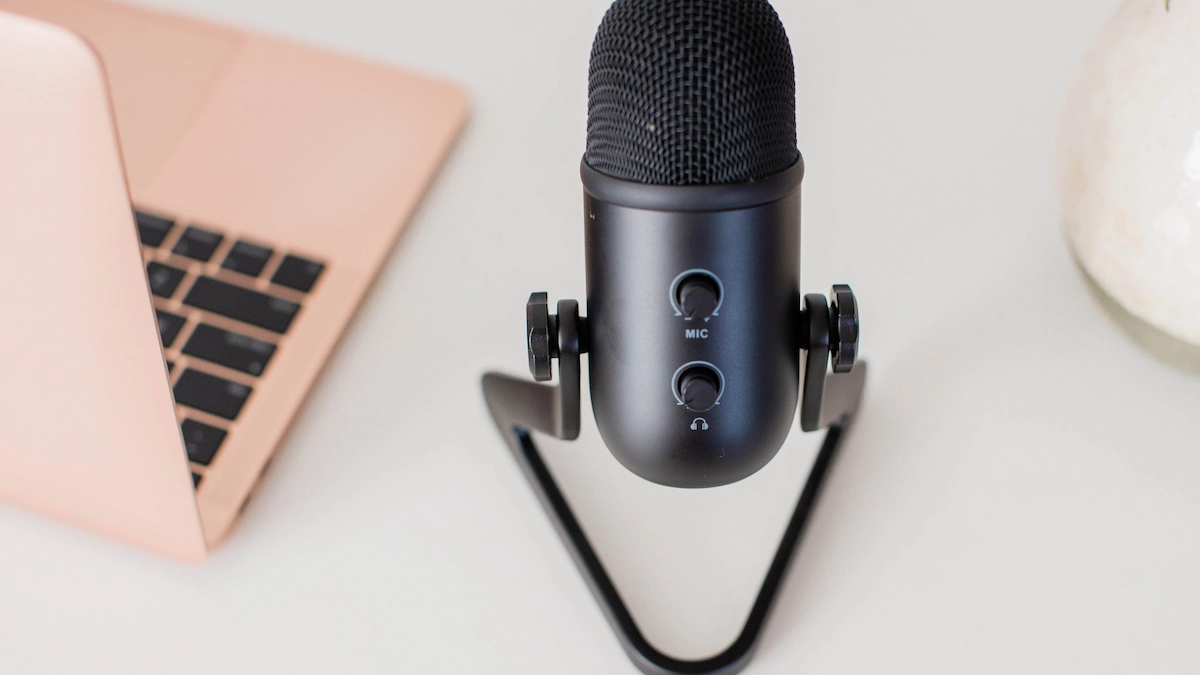 closeup of podcast recording microphone and laptop